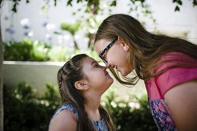 Girls smiling at each other